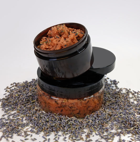 A 4oz Rosé Marmalade Scrub stacked on an 8oz container of the product. Lavender petals are scatters all around the product.